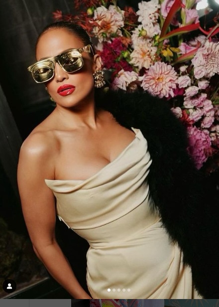 J.Lo dressed in high fashion dress and sunglasses
